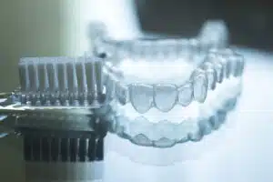 Clear aligners being cleaned as part of the Invisalign care routine