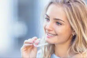 Patient holding Invisalign aligners