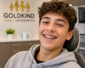 Teen smiling with braces during orthodontic visit
